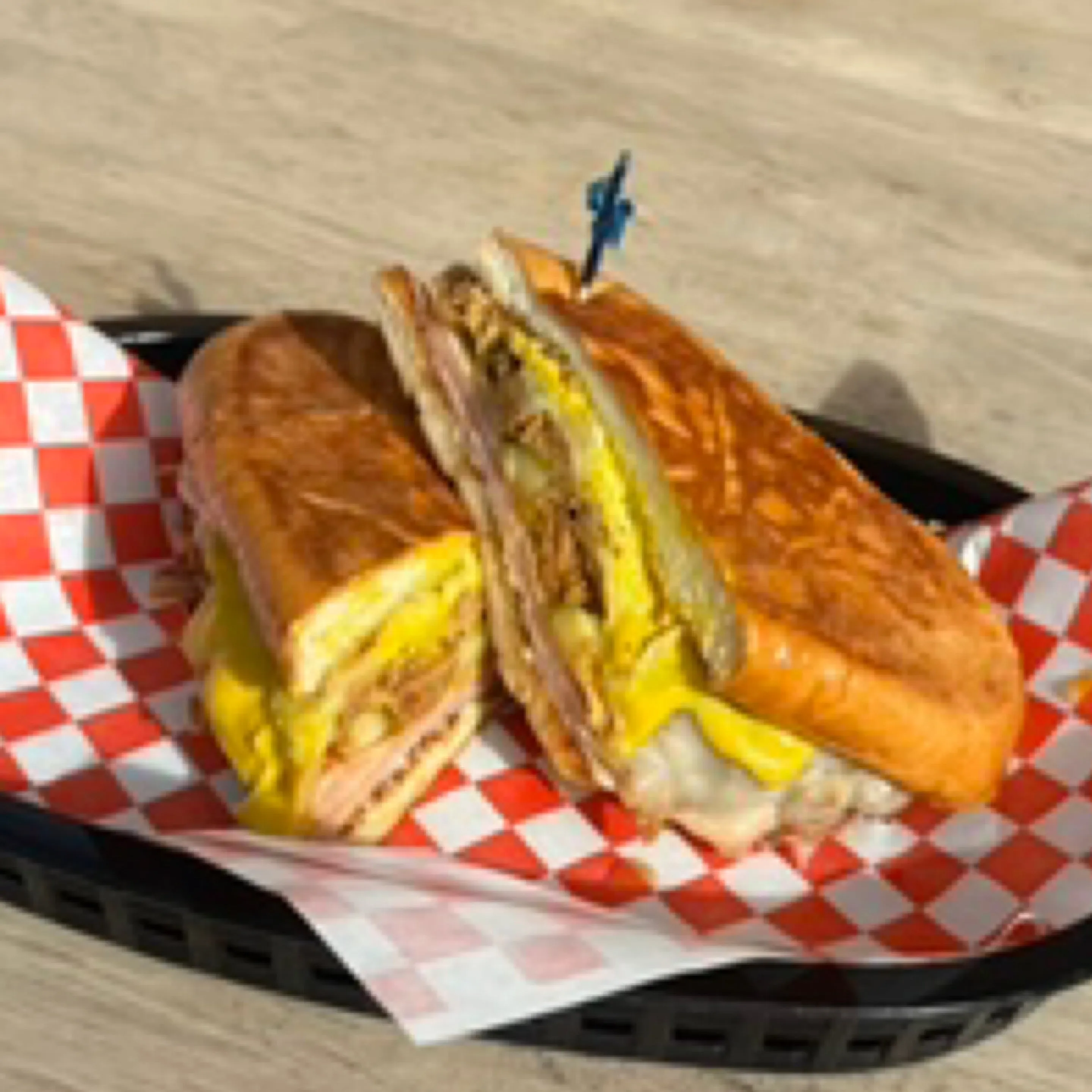 Pressed Cubano sandwich in a red deli basket